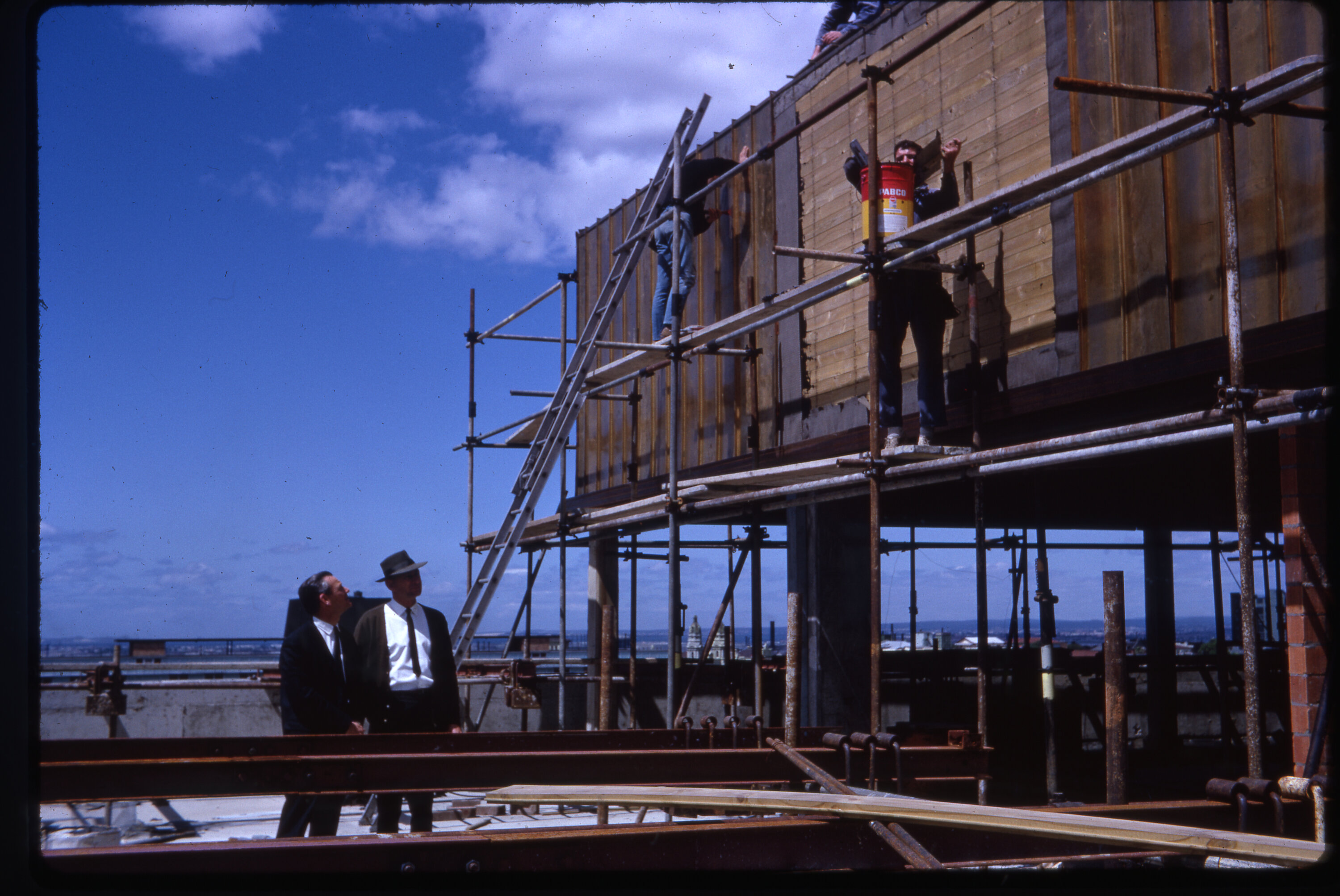 Workers install wall panelling on top floor of Library