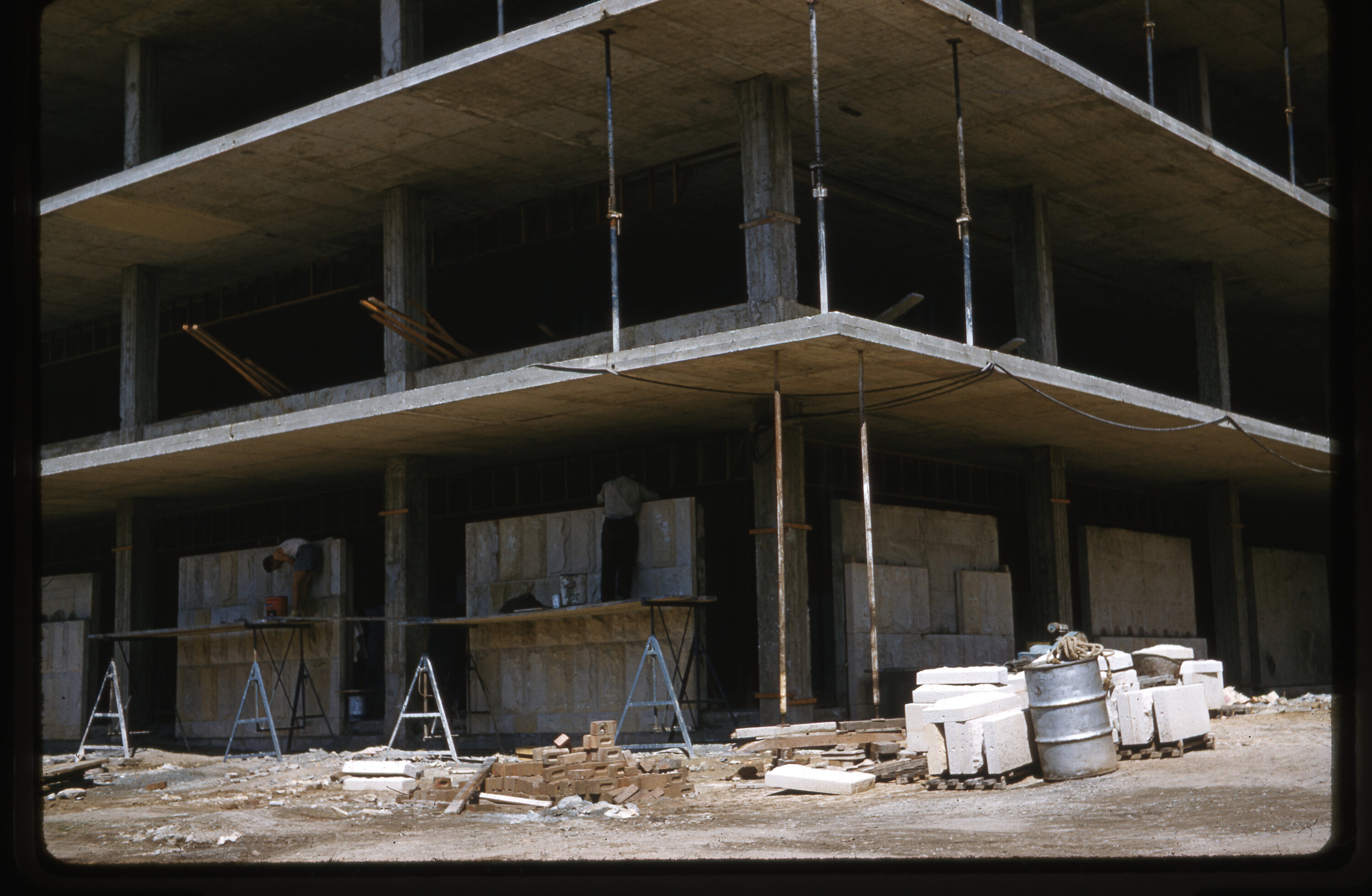 Workers construct stone wall