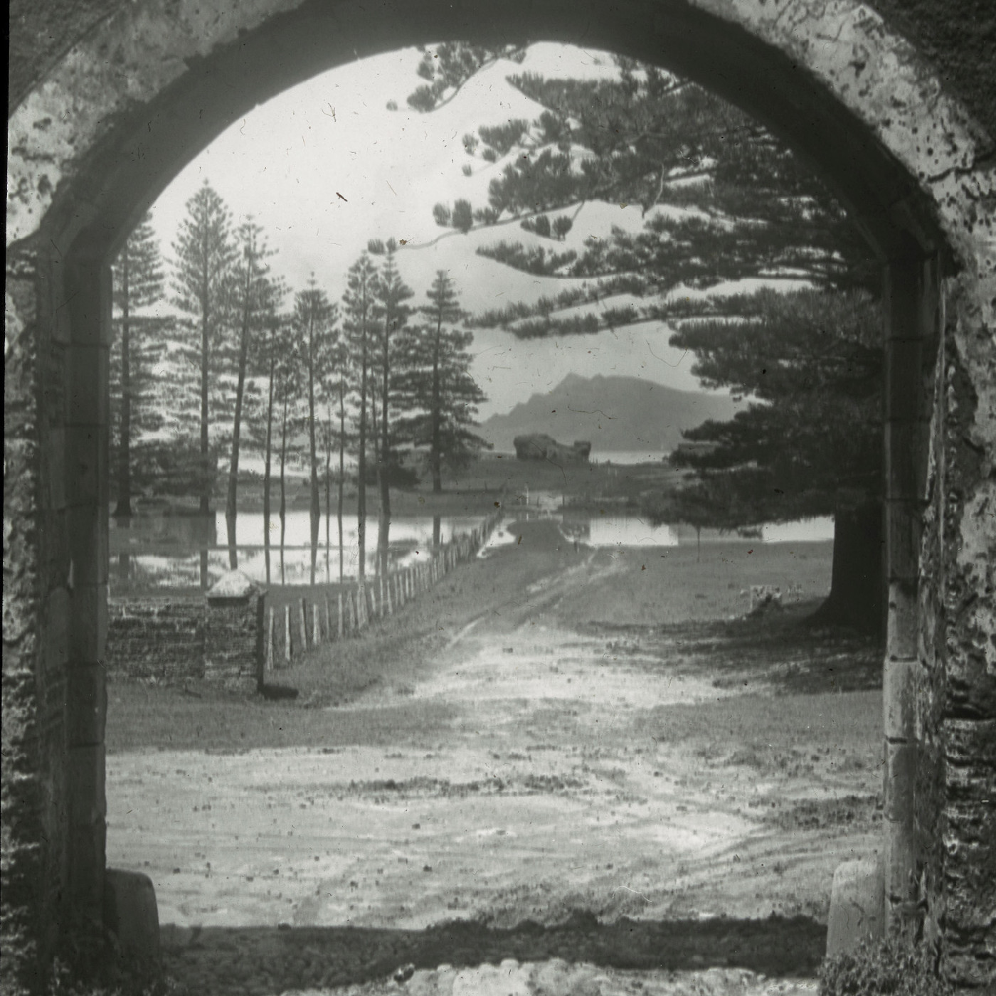 Phillip Island seen through a stone archway at Kingston, Norfolk Island