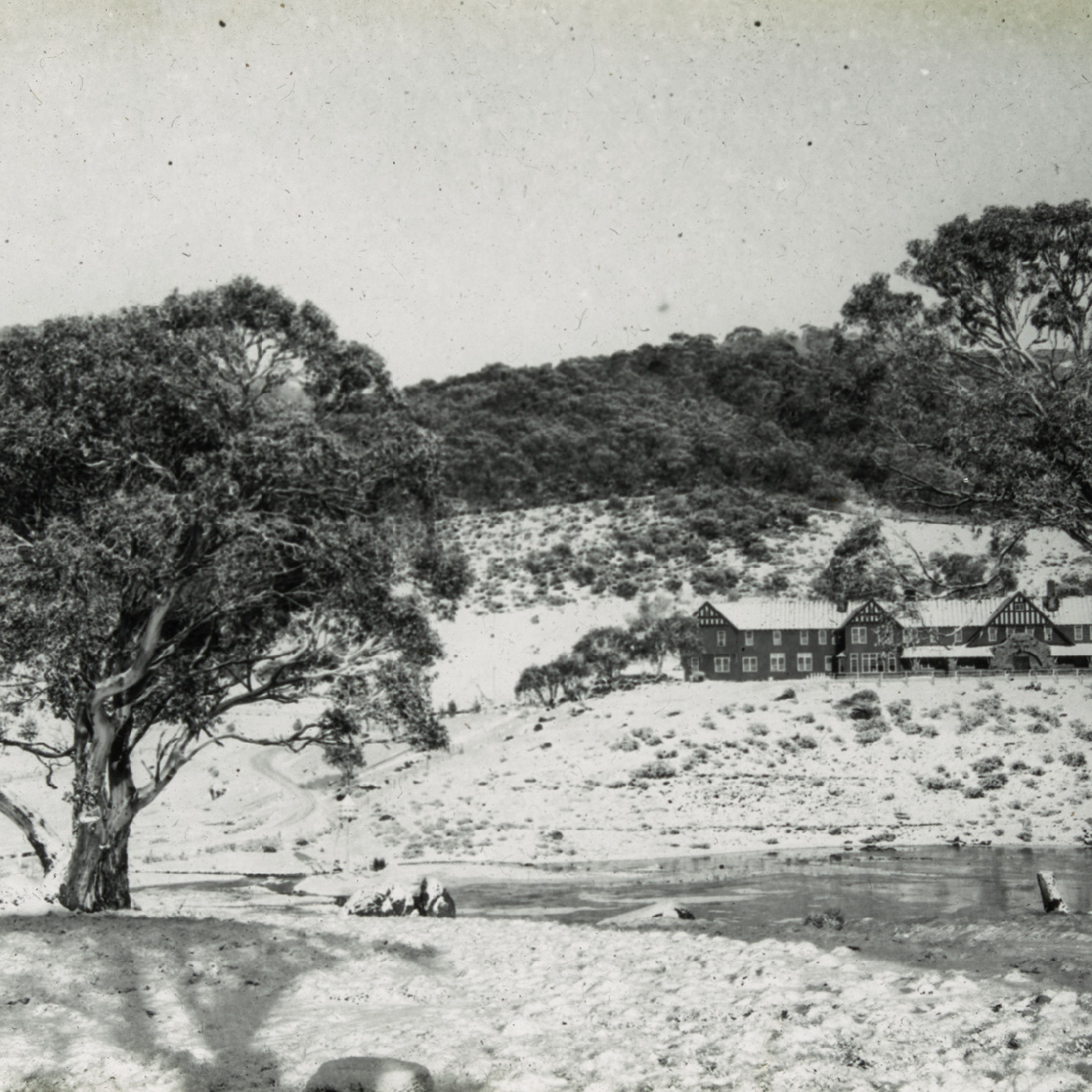 Snowy landscape with a house beyond the river (Hotel Kosciusko NSW)