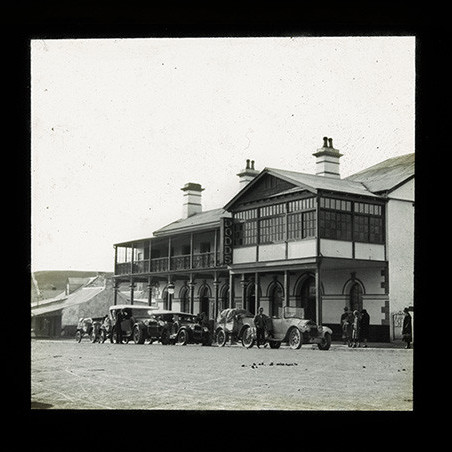 Vintage cars with trailers outside DODDS 