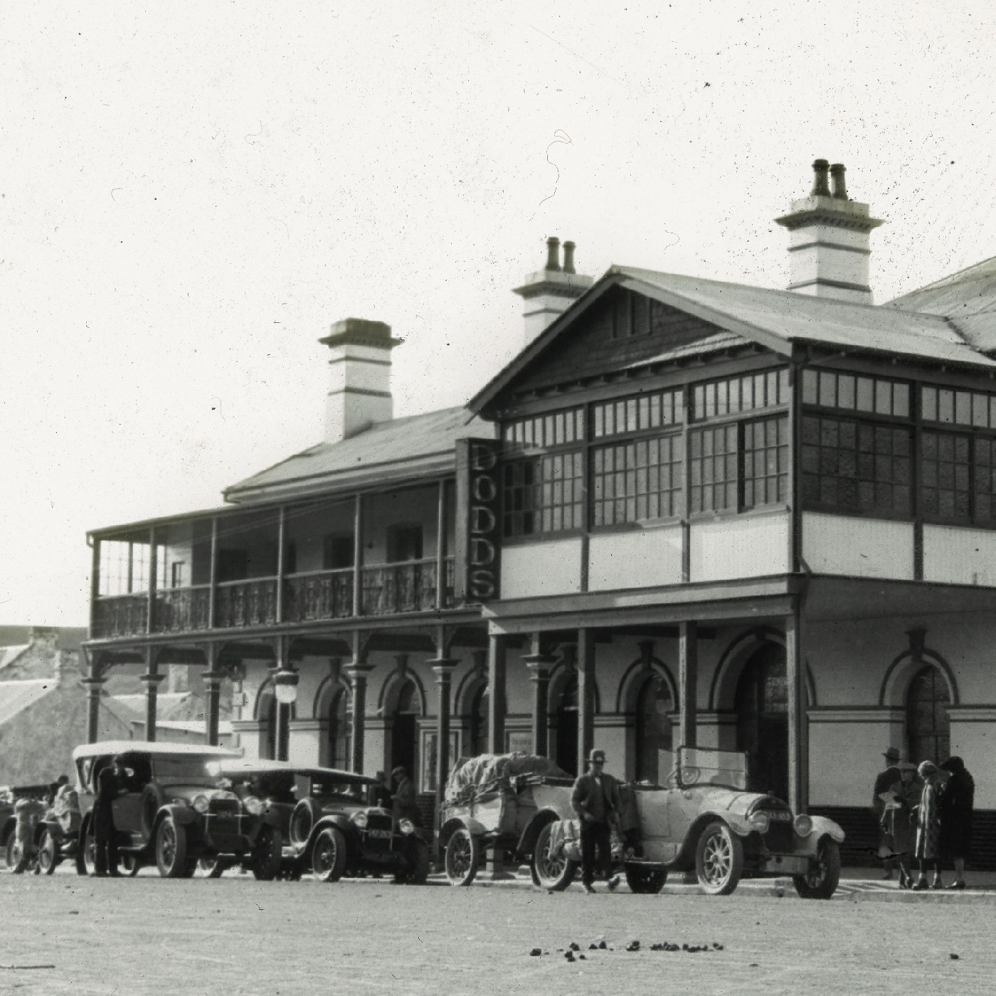 Vintage cars with trailers outside DODDS 