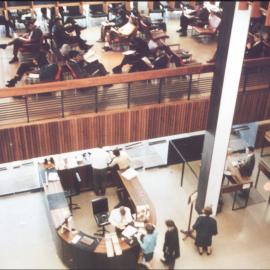 View from Level 5 of Fisher Library down to Level 4 Music Listening Area and Level 3 Foyer with horseshoe desk