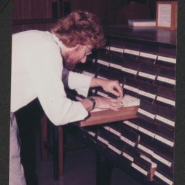 Student using the Library card catalogue, Fisher Library, 1977