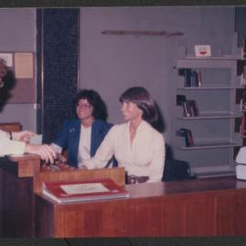 Student in conversation with Library staff, Fisher Library, 1977