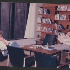 Relaxing and reading, Fisher Library, 1977