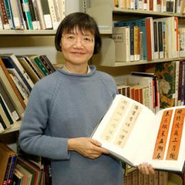 Librarian showing item from East Asian collection
