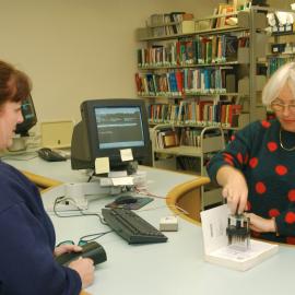 Library staff member at information desk, 2002