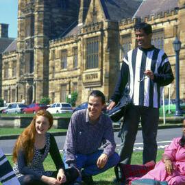 Students sitting on the front lawns of University of Sydney