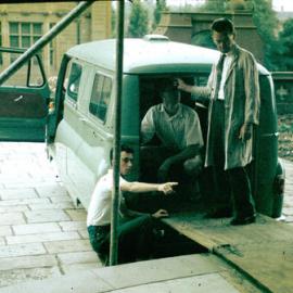 Owen Slight helping to prepare van used to move collection to Fisher Library, 1962