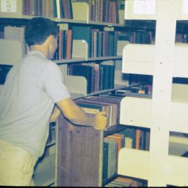 Books to be unloaded from trolley in Fisher Library Stack, 1962