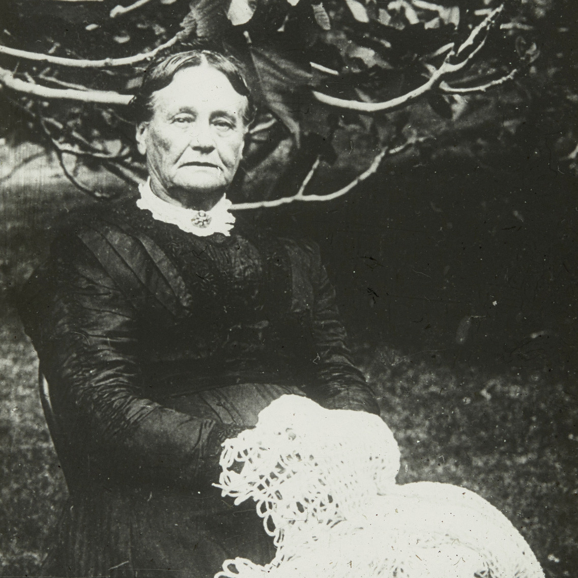 Portrait of unidentified person seated outside