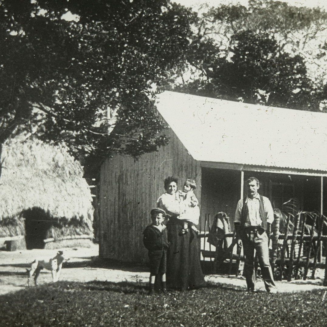 Portrait of family in front of house, Lord Howe Island