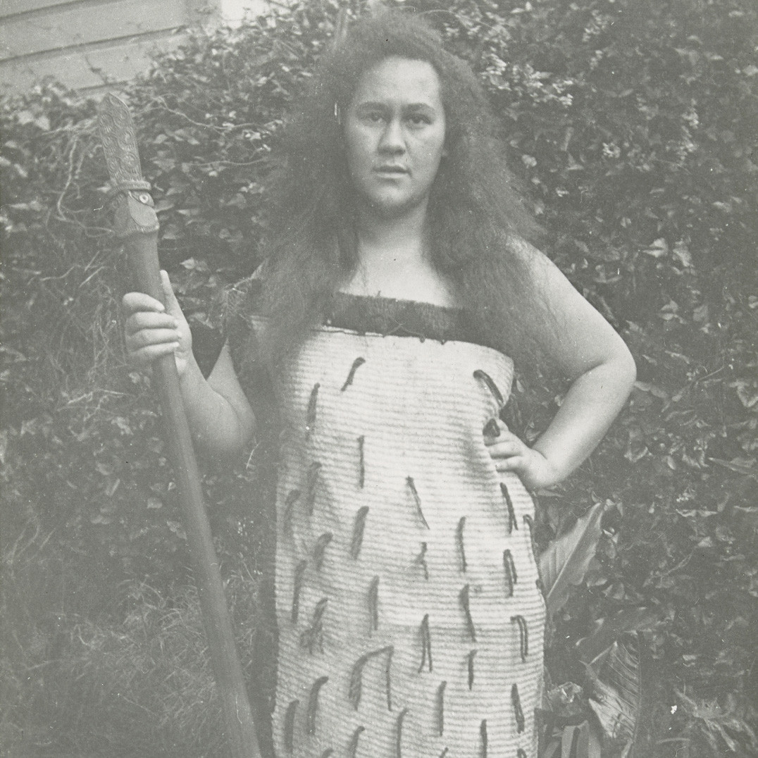 Person in traditional Maori dress with orator's staff/tokotoko