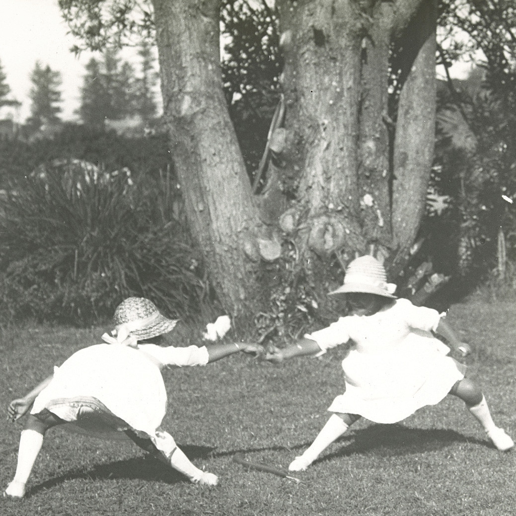 Val & Florrie Buffett playing in the garden, Norfolk Island